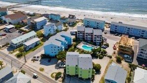 A coastal residential area with multi-story buildings, a beach, and a pier. - A Shore Oasis 1 Bedroom Villa (Carolina Beach)