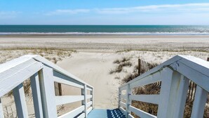 A beach view with a wooden staircase leading down to the sand. - Shady Shack West a 3 BR Oceanfront Duplex with Unobstructed Ocean Views (Emerald Isle)