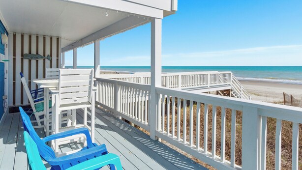 A wooden deck with white railings overlooking a beach. - Shady Shack West a 3 BR Oceanfront Duplex with Unobstructed Ocean Views (Emerald Isle)