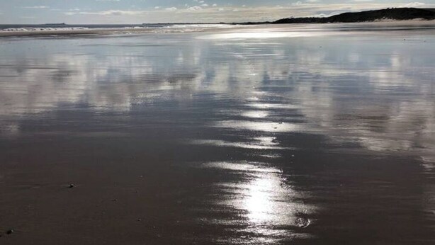 A beach with calm waters reflecting the sky. - The Mill set in stunning rural Northumberland (Netherton)