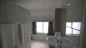 A modern bathroom with a large mirror, two sinks, and a shower area. - Little Bush Guesthouse (Omaruru)
