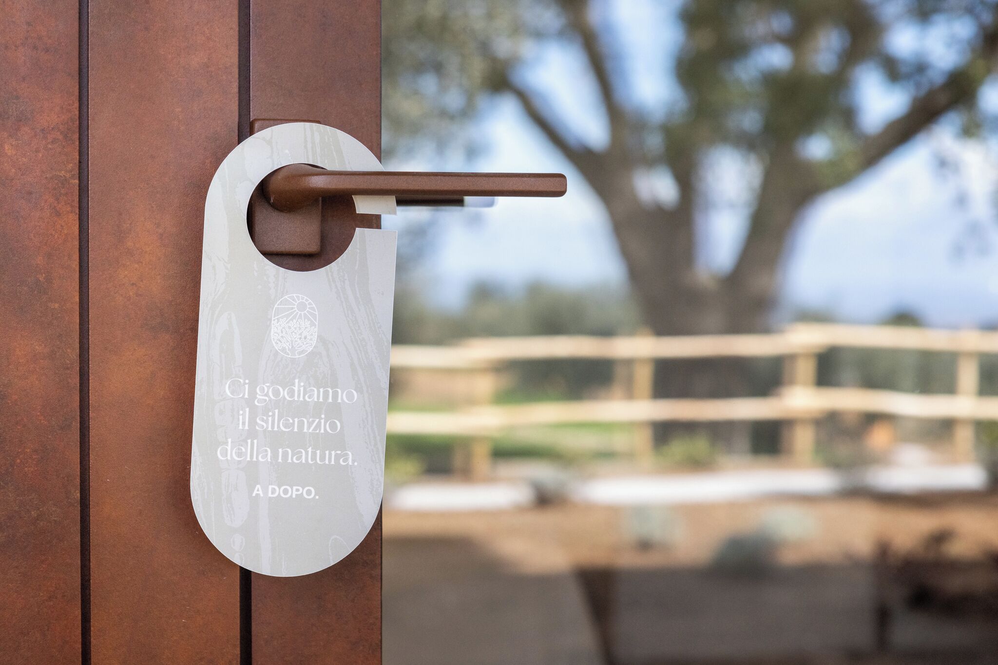 Una puerta con manija y una placa con una cita en italiano.
