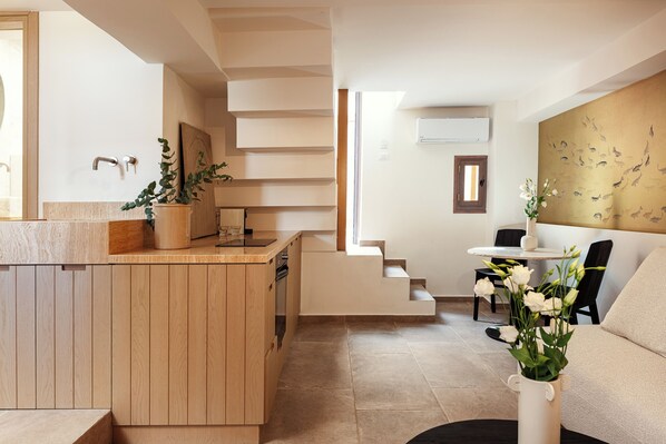 A modern kitchen with wooden cabinetry, a built-in stove, and a potted plant.