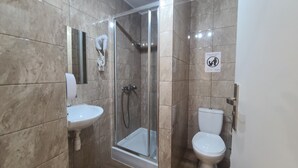 A bathroom with a glass-enclosed shower, a sink, and a toilet. - Double apartment, Krakow Old Town (Kraków)