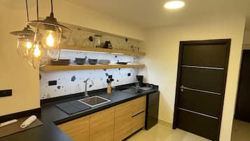 Fridge, microwave, coffee/tea maker, cookware/dishes/utensils