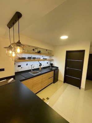 Fridge, microwave, coffee/tea maker, cookware/dishes/utensils