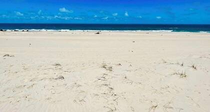 Beachfront fully-equipped 2-bedroom house near Beach Park with AC, WiFi.