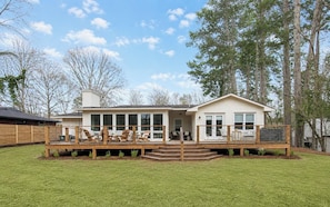 A two-story house with a deck, a covered patio, and a fenced backyard. - The 9th Street Luxe Retreat by Velvet Ditch Villas (Oxford)