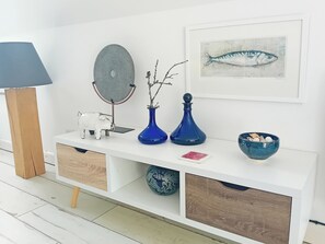 A white console table with a lamp, decorative items, and a framed fish painting. - Valley Lodge - UK49228 (Gunnislake)