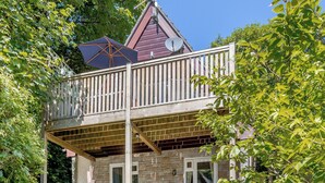 A two-story house with a balcony, stone walls, and a satellite dish. - Valley Lodge - UK49228 (Gunnislake)