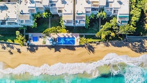 A coastal hotel with multiple balconies, a swimming pool, and a beach view. - Blue Green (Sosúa)