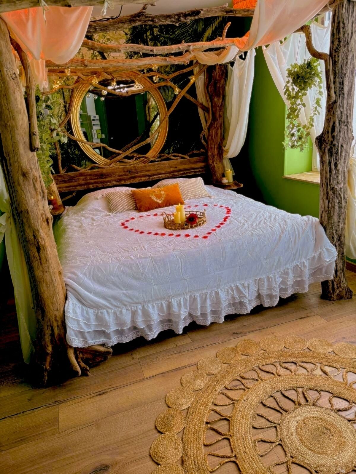 A cozy bedroom with a rustic design, featuring a bed with a white bedspread, a woven headboard, and a circular woven rug on the floor.