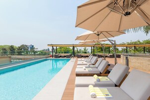 Una piscina al aire libre, sombrillas, guardavidas en la propiedad