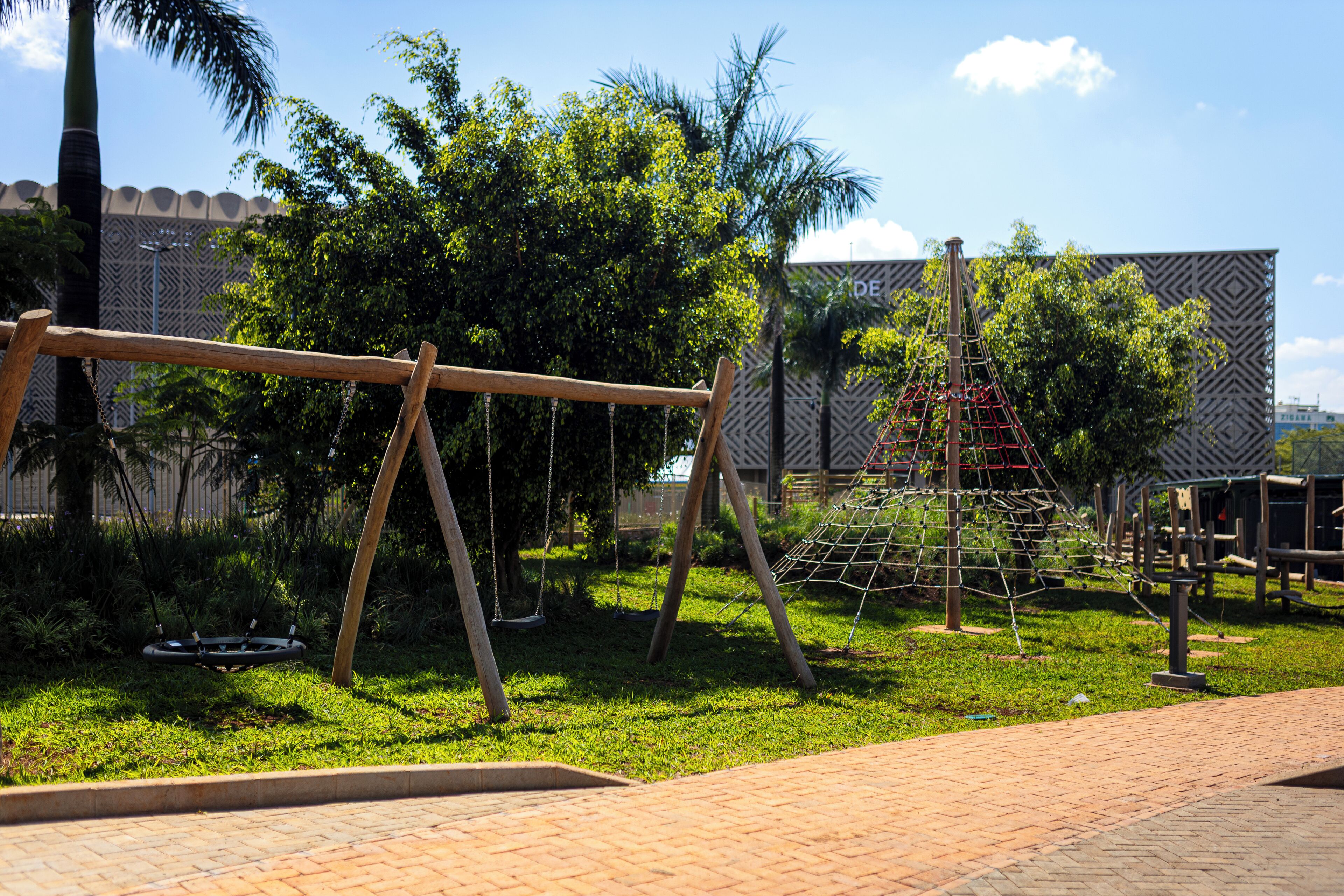 A playground with swings and a climbing structure.