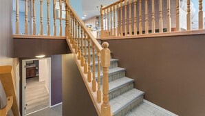 A staircase with wooden balusters and a carpeted landing.