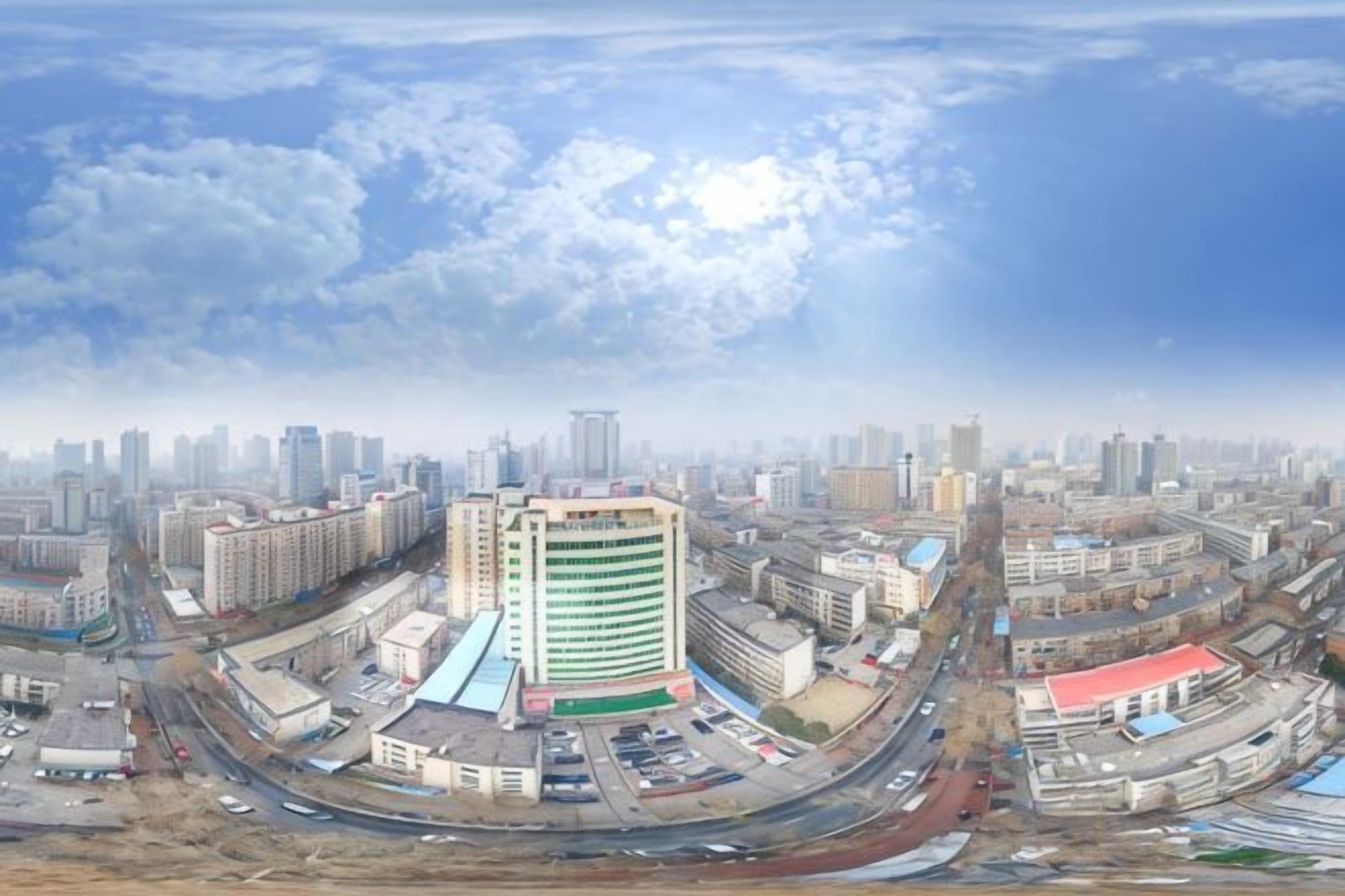 A cityscape with a prominent multi-story building, roads, and surrounding infrastructure.