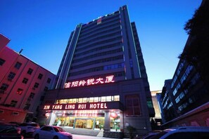 A multi-story hotel building with signage for 'XIN YANG LING RUI HOTEL' and 'XIN YANG LING RUI HOTEL' in large letters. - Zhengzhou Xinyang Lingrui Building Hotel (Provincial People's Hospital Metro Station) (Zhengzhou)