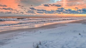 A beach with a wide sandy area and a view of the ocean. - Waterfront ~ Ohana  ~ Sleeps 10 (Dauphin Island)