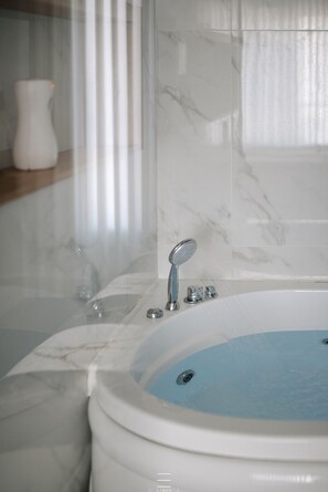 Jetted bath, towels, soap, toilet paper