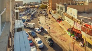 A city street with parked cars and buildings. - Grand Season hotel (Aqaba)