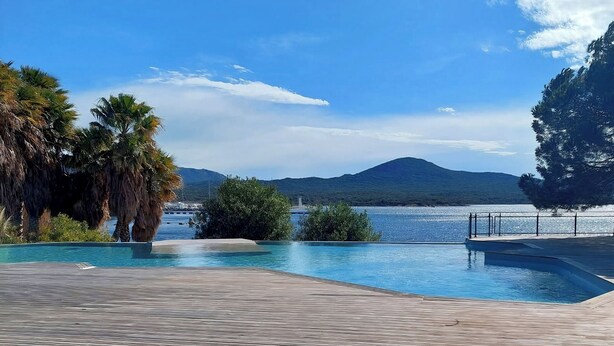 A swimming pool with a view of a mountain and a body of water. - T2 seaside apartment - pianottoli-caldarello (Pianottoli-Caldarello)