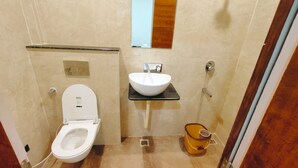 A compact bathroom with a toilet, a sink, and a bidet. - Hotel Babylon Regency  (Mathura)