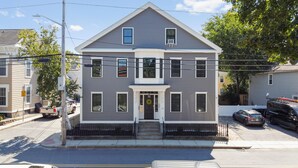 A two-story house with a front porch, a garage, and a driveway. - Updated & Great Downtown Location, Built 1841 (Salem)