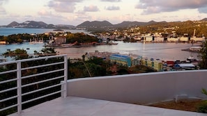 A coastal cityscape with a view of the sea, buildings, and mountains in the background. - Awesome Homes - Harbour View (Castries)