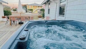 A hot tub with a wooden deck and outdoor furniture. - Hidden gem in Kure|2min walk to Beach|Hot Tub (Kure Beach)
