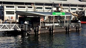 A docked boat with a covered seating area and a sign reading "Pymont Bay". - Walking Distance to Darling Harbour (Sydney)