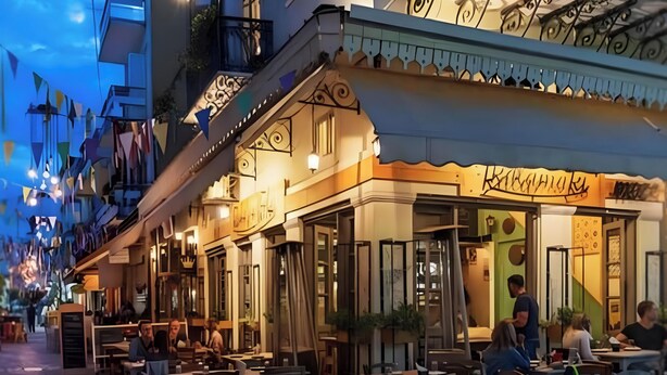An outdoor dining area with tables and chairs, a staircase, and a building with a balcony. - Apartment 'Meliti Kalamata' with Mountain View, Wi-Fi and Air Conditioning (Unknown)