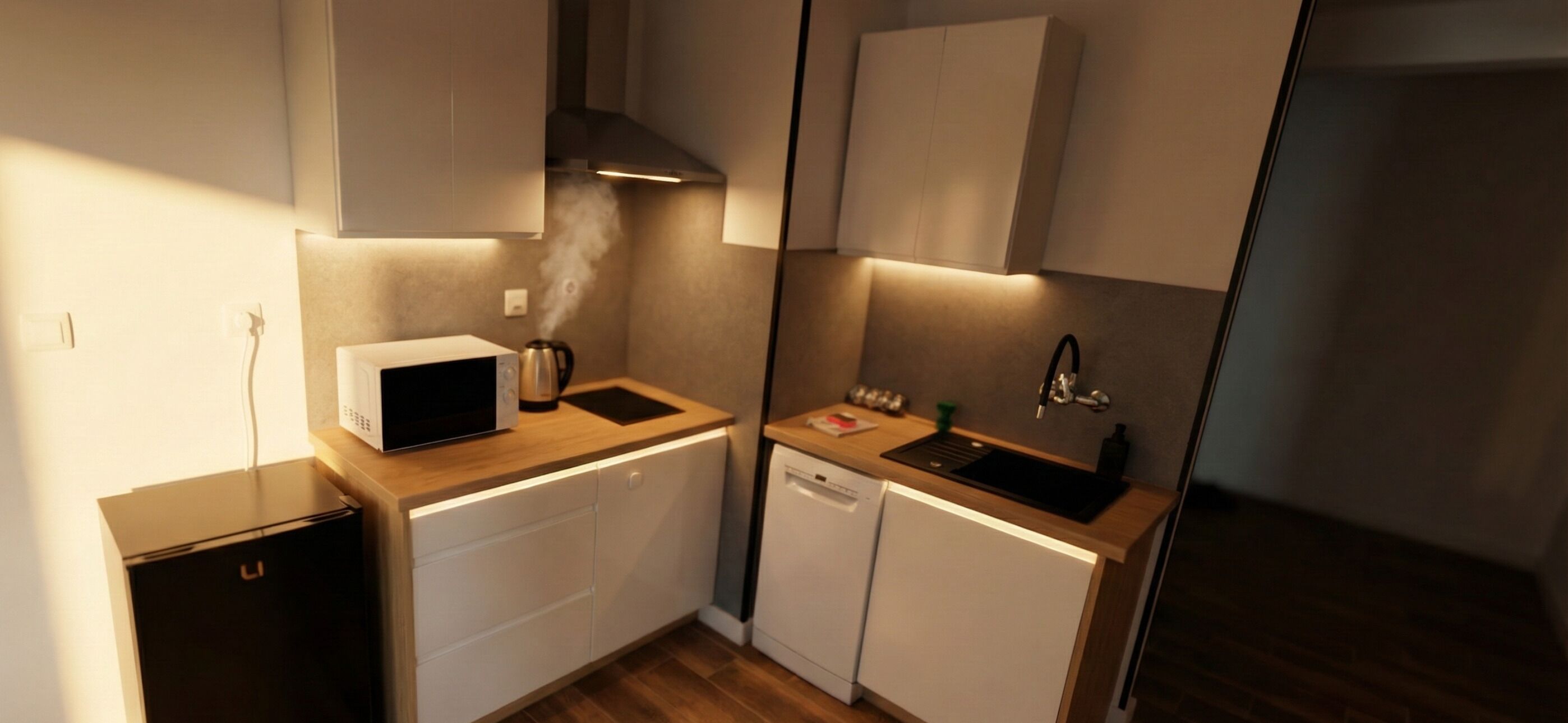 A compact kitchen with a microwave, coffee maker, sink, and dishwasher.