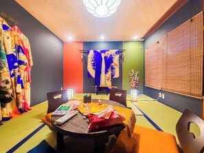 A room with a dining table, chairs, a ceiling fan, and a wall-mounted TV. - Lamer-GION (Kyoto)