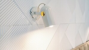 A ceiling with a white, ribbed design and a central light fixture.