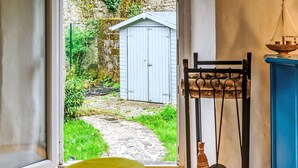 A room with a wooden floor, a yellow stool, a broom, and a blue cabinet. - Maison de Langonnet by Interhome (Langonnet)