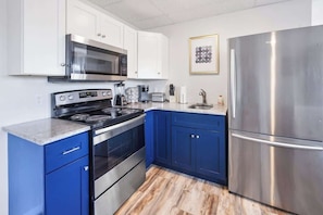 Fridge, microwave, stovetop, coffee/tea maker