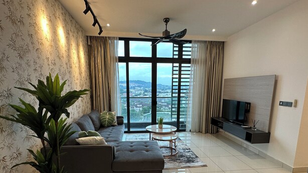 A modern living room with a sectional sofa, a coffee table, and a TV. - Green Haven (Masai)