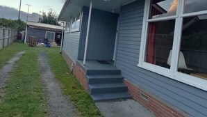 A single-story house with a front porch and a small attached garage.