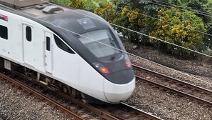 A train on tracks with a view of agricultural fields in the background. - ZZZ HOTEL (Jiaoxi)