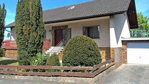 A single-story house with a tiled roof, a front porch, and a garage. - Exclusives Ferienhaus in Frankenau im Sauerland (Frankenau)
