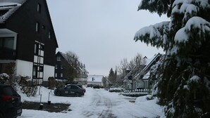 A residential street with snow-covered houses and parked cars. - Ferienwohnung in Winterberg am Skigebiet (Winterberg)