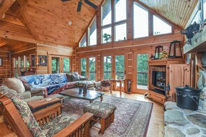 A spacious cabin with a large living area featuring a sofa set, a coffee table, and a fireplace. - Bair Necessities relaxing Cabin (Old Fort)