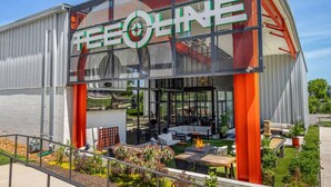 A modern building with the sign "TEEOLINE" prominently displayed.