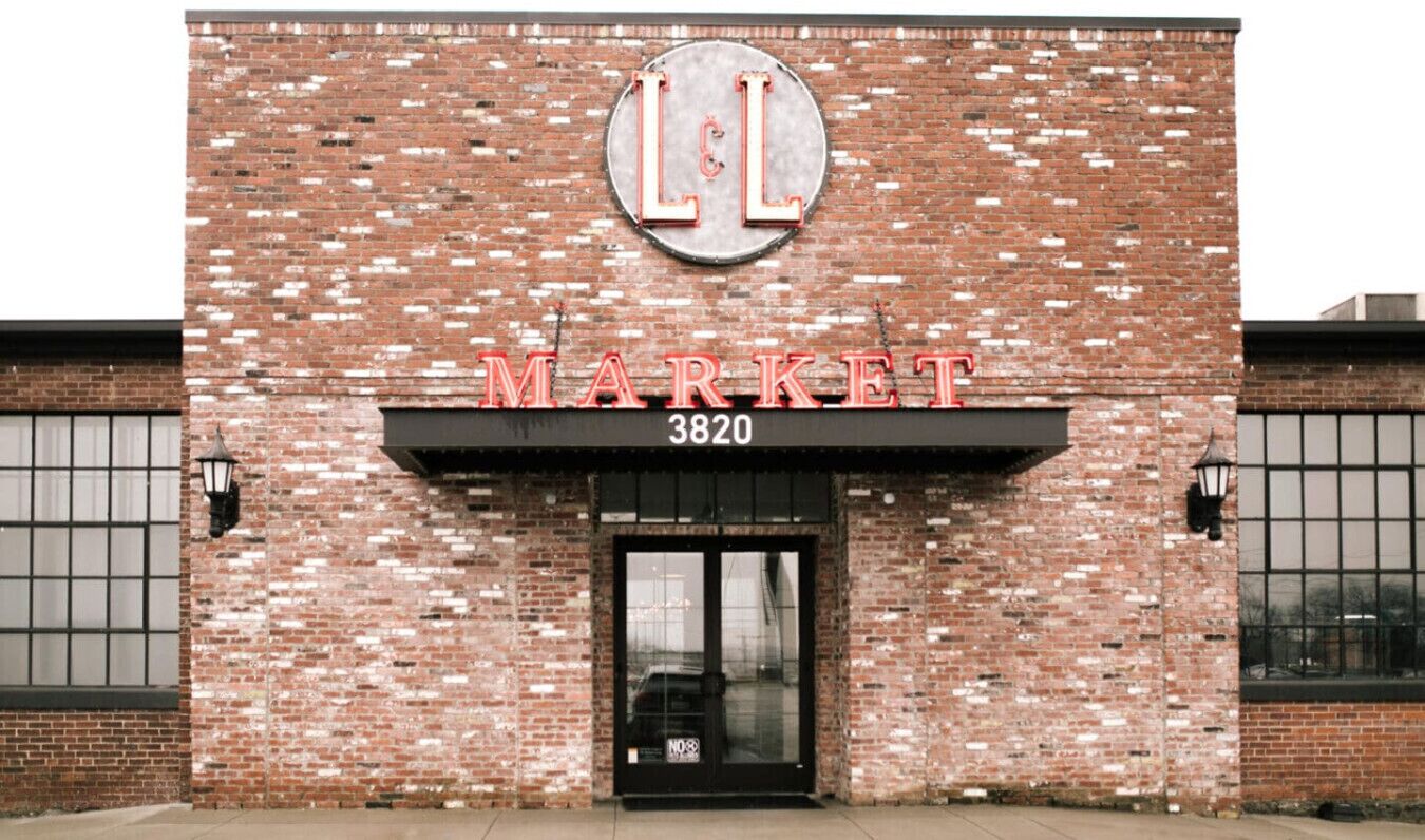 A brick building with a sign reading "L&L MARKET 3820" above the entrance.