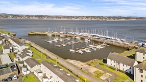 A marina with boats docked, surrounded by residential buildings.