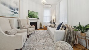 A living room with a fireplace, a sofa, a chair, and a coffee table. - Bisham Cottage
Fully renovated two bedroom Cottage with a brand new out door Spa (Katoomba)
