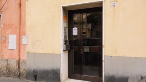 A building entrance with a glass door, a mailbox, and a utility box.