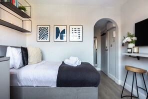 Departamento, 1 habitación, para no fumadores, vista a la ciudad | Área de sala de estar