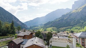 A town nestled in a valley with mountains in the background. - The Cristal apartment house is situated in a quiet, sunny and central location (Leukerbad)