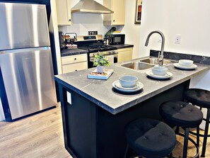 Fridge, microwave, oven, stovetop - Sleek+Serene ADU - Modern Kitchen • Outdoor Vibes (Carmichael)